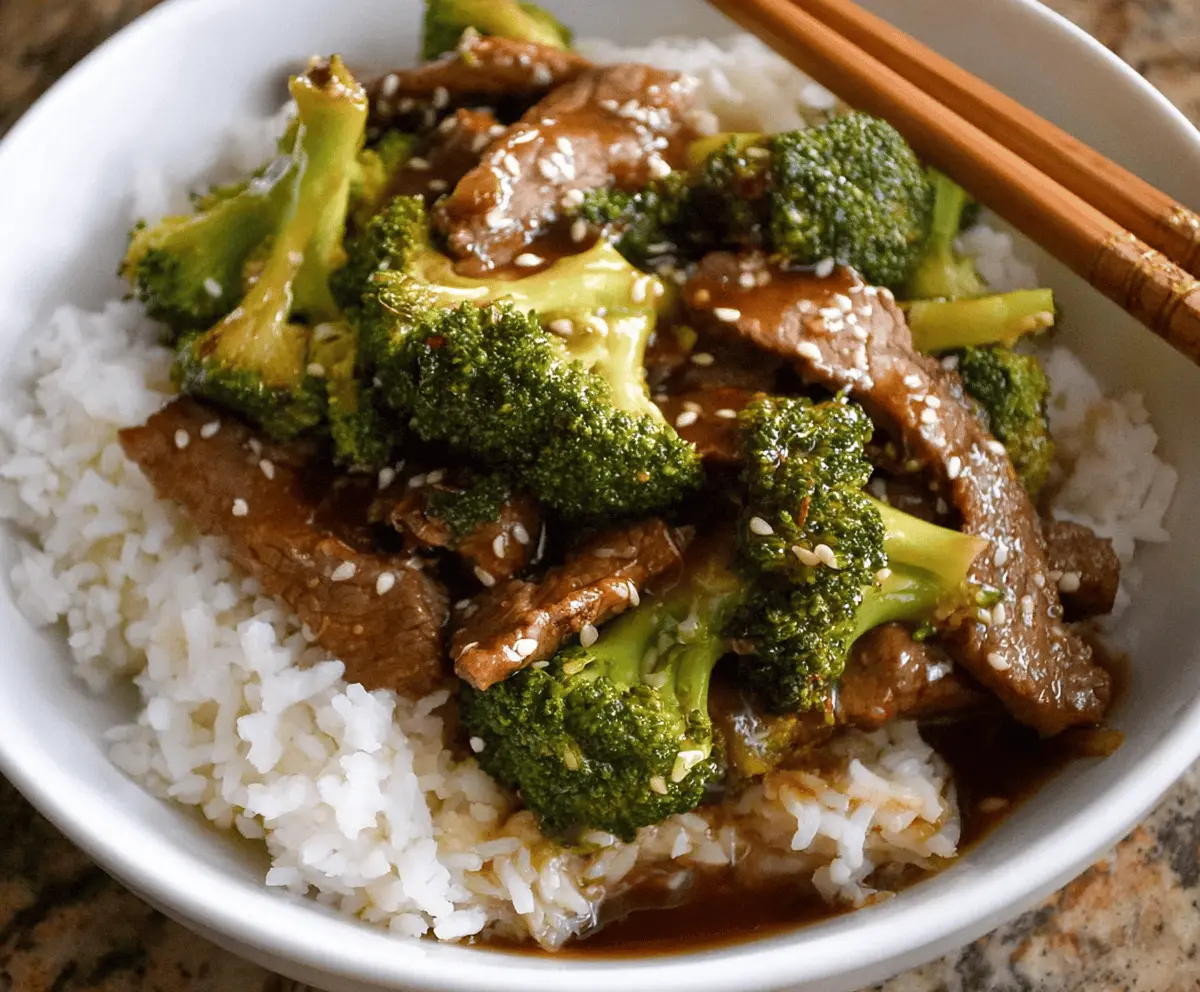 Delicious Chinese Beef and Broccoli stir-fry with tender beef slices and fresh broccoli florets served on a white plate
