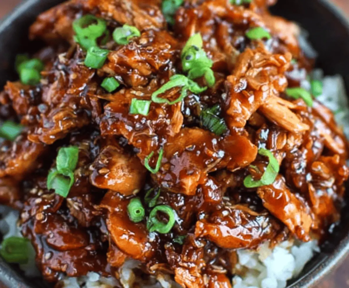 Delicious Crock Pot Bourbon Chicken served with rice and vegetables, featuring tender chicken glazed in a savory bourbon sauce