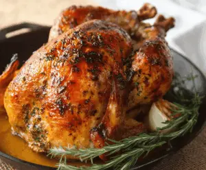 Juicy roasted turkey topped with garlic herb butter, garnished with fresh herbs, ready for a festive feast