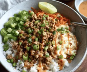 Delicious ground turkey rice bowl topped with Bang Bang sauce, perfect for a healthy meal.