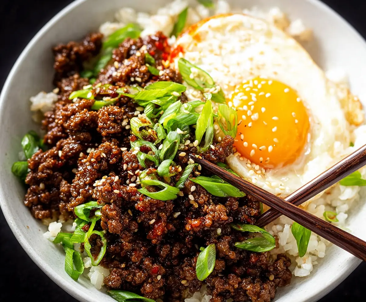 Delicious Korean Ground Beef Bowl served with rice, vegetables, and a savory sauce.