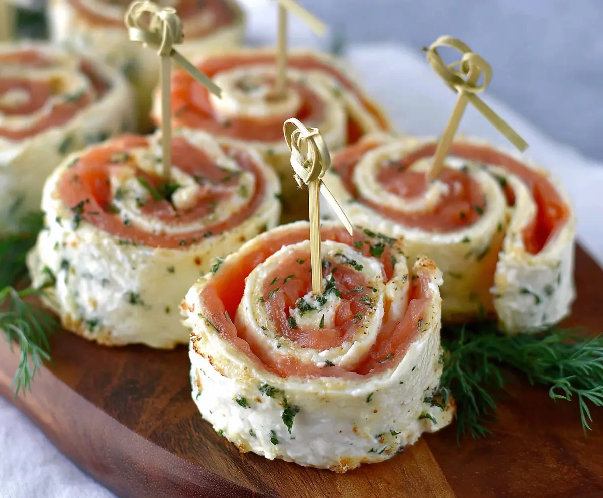Delicious easy smoked salmon pinwheels on a platter, perfect party appetizers ready to serve.