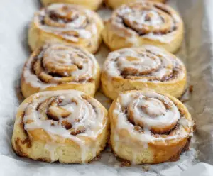 Delicious 30-minute sourdough discard cinnamon rolls fresh out of the oven, showcasing swirled cinnamon filling and golden brown tops.