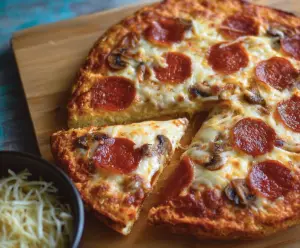 Delicious gluten-free pizza dough ready to be baked, showcasing a perfect blend of healthy ingredients.