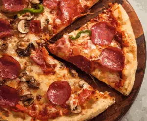 Delicious homemade pizza with colorful toppings including peppers, olives, and melted cheese.